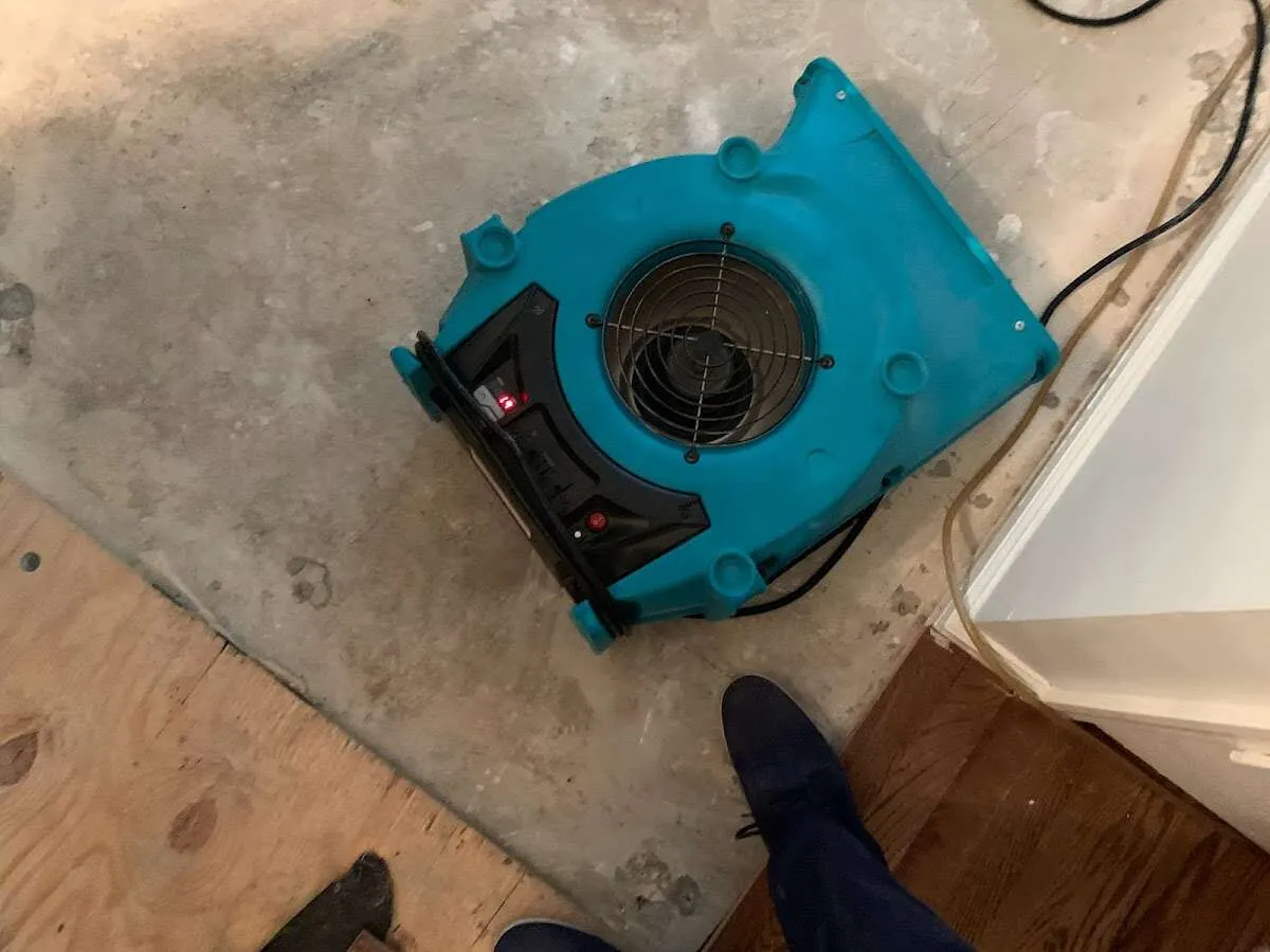 Air mover drying subfloor during Commercial Water Damage Restoration in Oneida